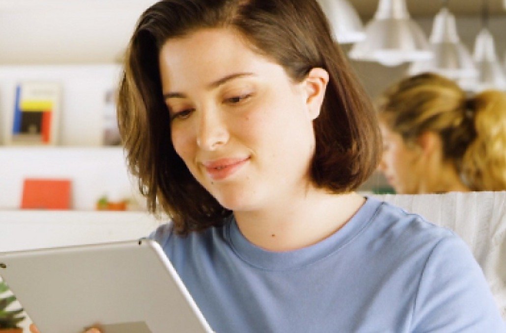 A woman at her desk reviewing a list of tasks her automations have already completed